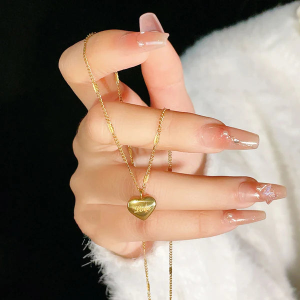 Heart golden pendant with love engraved