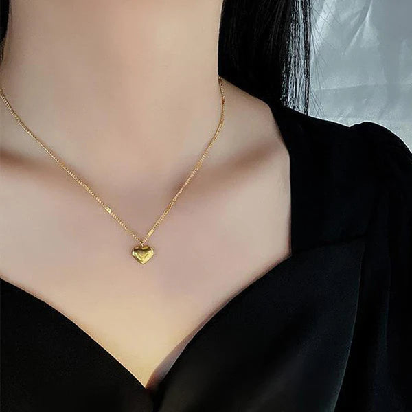 Heart golden pendant with love engraved